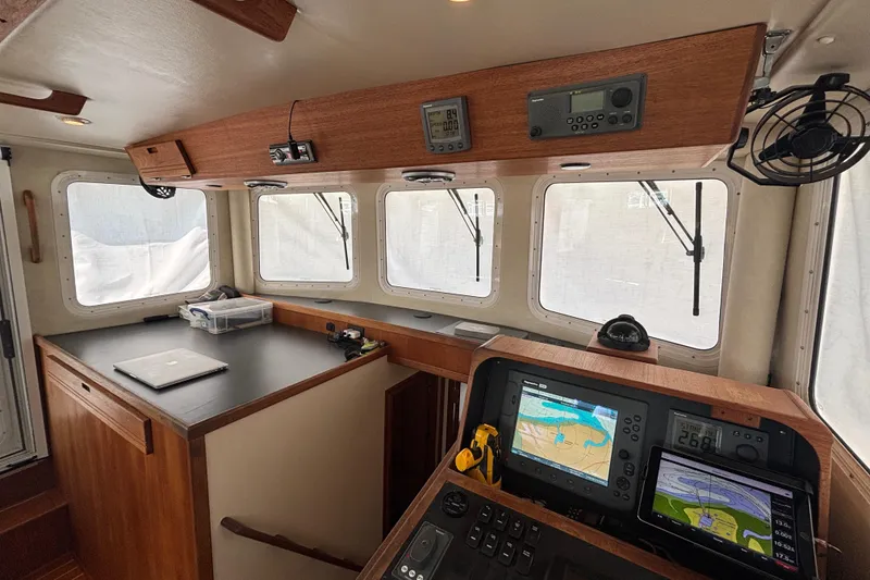 Slide: The Image of Pilothouse of 2005 Nordic Tug 37 Flybridge with navigation equipment and wooden cabinetry. - 41