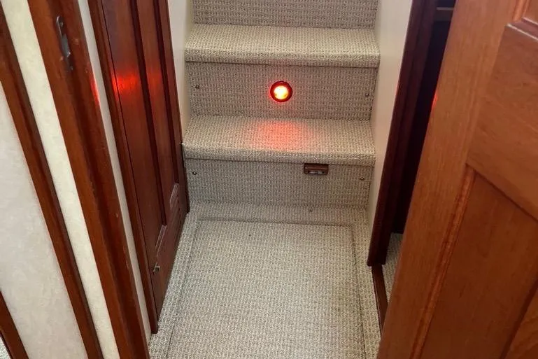 Slide: The Image of Carpeted stairs with red light on 2005 Nordic Tug 37 Flybridge. - 45