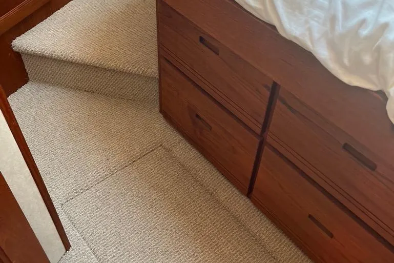 Slide: The Image of Carpeted stairs and wooden drawers in 2005 Nordic Tug 37 Flybridge interior. - 46