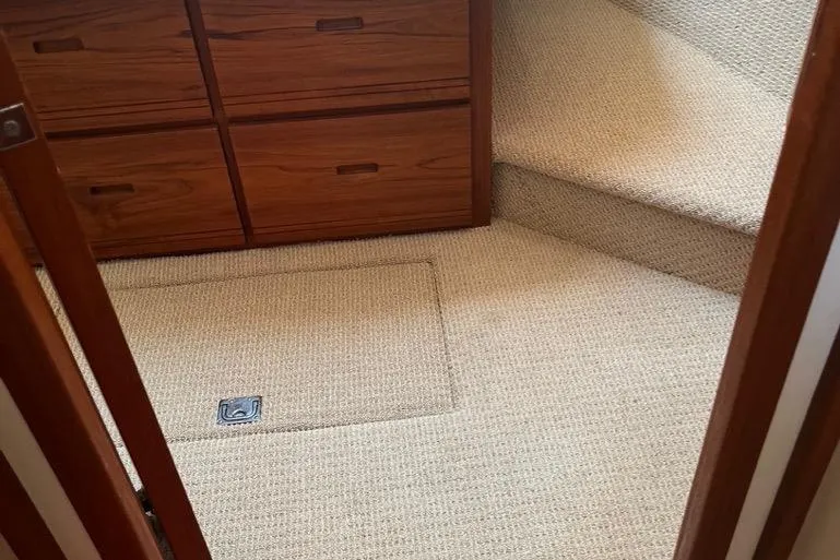 Slide: The Image of 2005 Nordic Tug 37 Flybridge interior with carpeted floor and wooden cabinetry. - 47