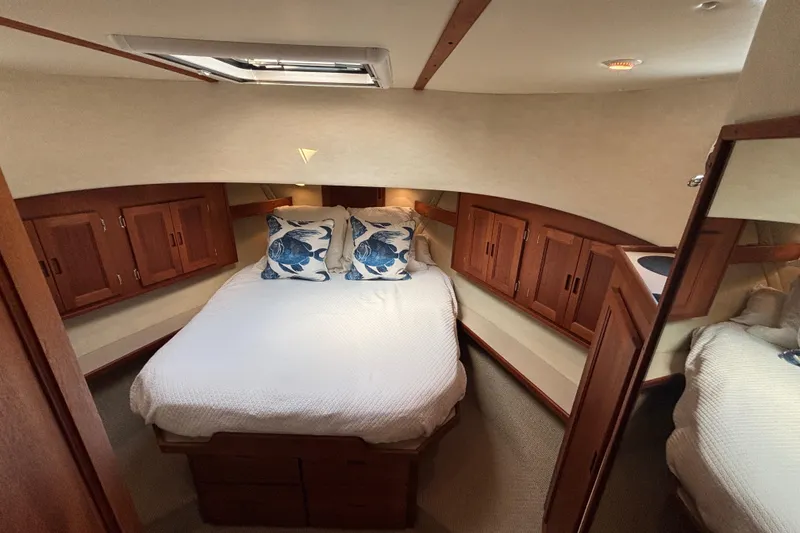 Slide: The Image of Cozy cabin interior of 2005 Nordic Tug 37 Flybridge with wooden cabinets and nautical decor. - 48