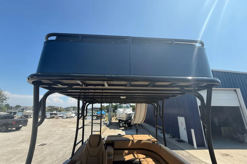 Slide: The Image of 2025 Tahoe Pontoon Cascade Cruise Funship with upper deck, parked near a marina. - 11