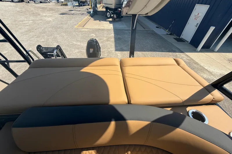 Slide: The Image of 2025 Tahoe Pontoon Cascade Cruise Funship with tan seating and cup holder, docked outdoors. - 12