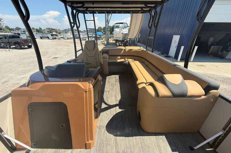 Slide: The Image of 2025 Tahoe Pontoon Cascade Cruise Funship interior with tan seating and helm station. - 17