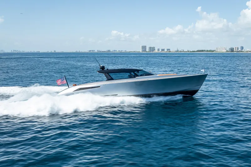 Slide: The Image of 2024 Wajer 55 HT yacht cruising on open water, city skyline in background. - 29