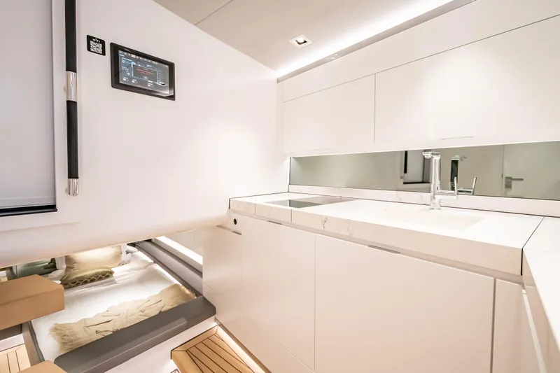 Slide: The Image of Modern kitchen interior of 2024 Wajer 55 HT yacht, featuring sleek white cabinetry and fixtures. - 46