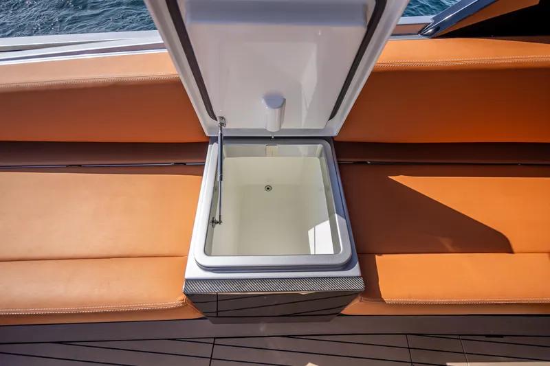 Slide: The Image of Open storage compartment on 2024 Wajer 55 HT yacht with orange seating. - 58