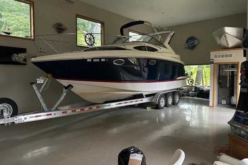 Slide: The Image of 2017 Regal 30 Express boat on trailer in a spacious garage. - 12