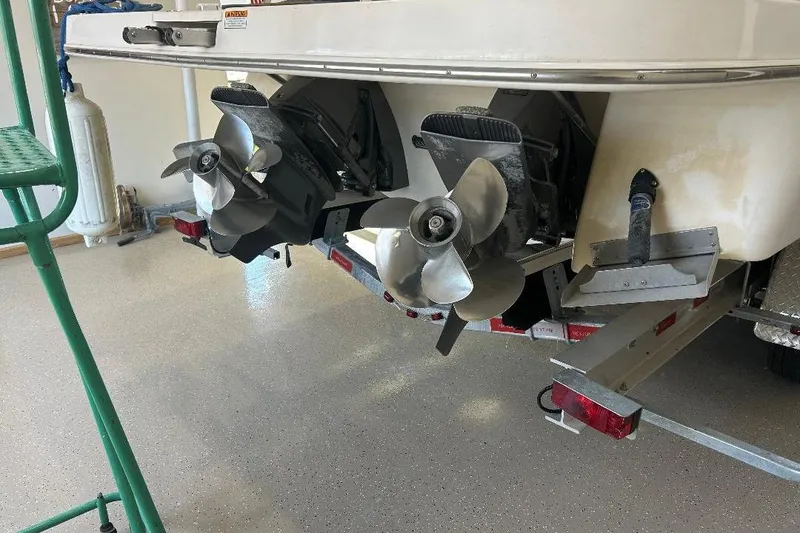 Slide: The Image of 2017 Regal 30 Express boat with dual propellers in a garage setting. - 14