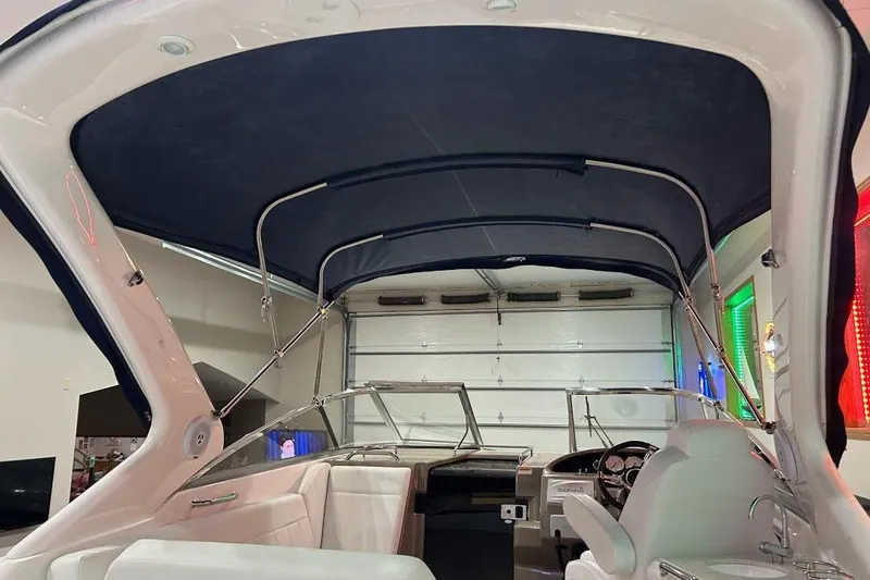 Slide: The Image of 2017 Regal 30 Express boat interior with blue canopy and white seating. - 16