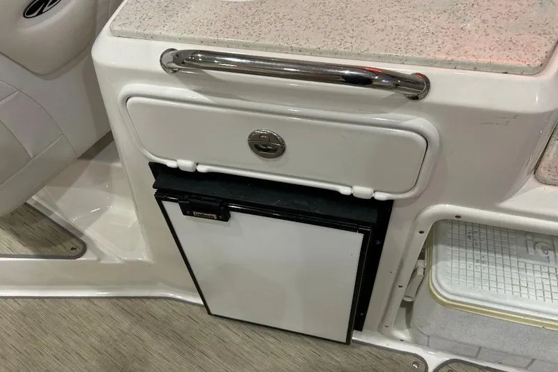 Slide: The Image of 2017 Regal 30 Express boat interior with compact refrigerator and storage compartment. - 4