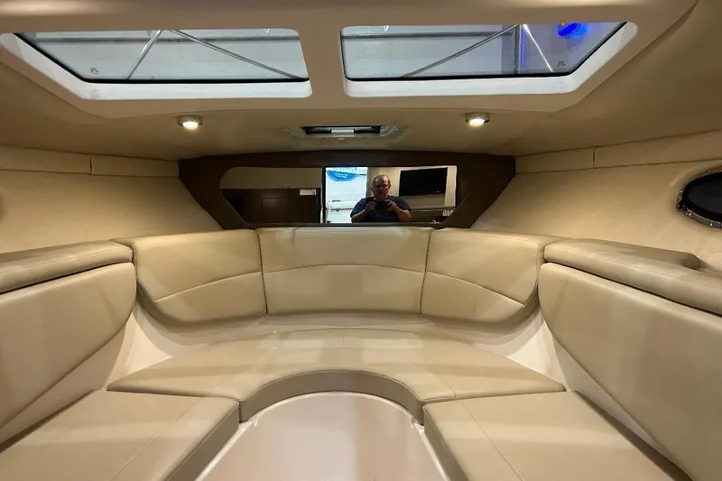 Slide: The Image of Interior of 2017 Regal 30 Express boat with beige seating and skylights. - 5