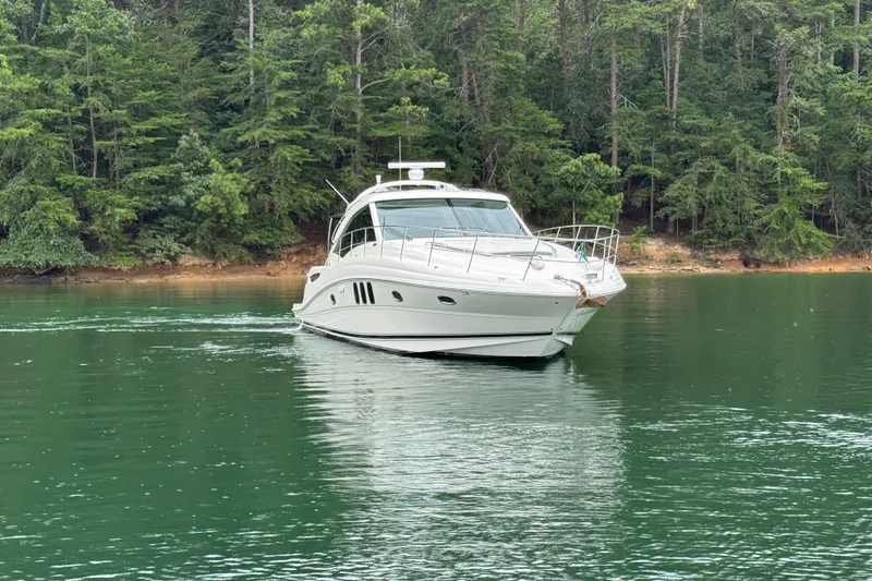 Slide: The Image of 2007 Sea Ray 48 Sundancer yacht on tranquil lake with forest backdrop. - 20