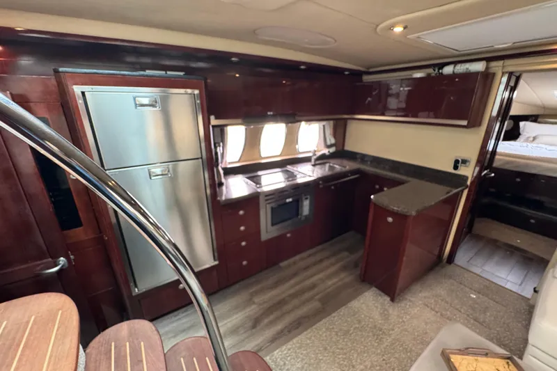 Slide: The Image of Luxurious 2007 Sea Ray 48 Sundancer yacht interior with modern kitchen and elegant wood finishes. - 28
