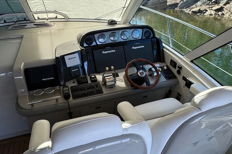Slide: The Image of 2007 Sea Ray 48 Sundancer helm with Raymarine electronics and luxurious seating. - 35