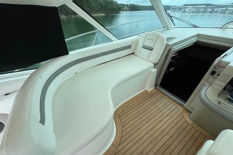 Slide: The Image of 2007 Sea Ray 48 Sundancer interior with white seating and wooden flooring. - 37