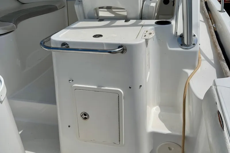 Slide: The Image of 2005 Boston Whaler 305 Conquest boat interior with storage compartment and seating. - 23