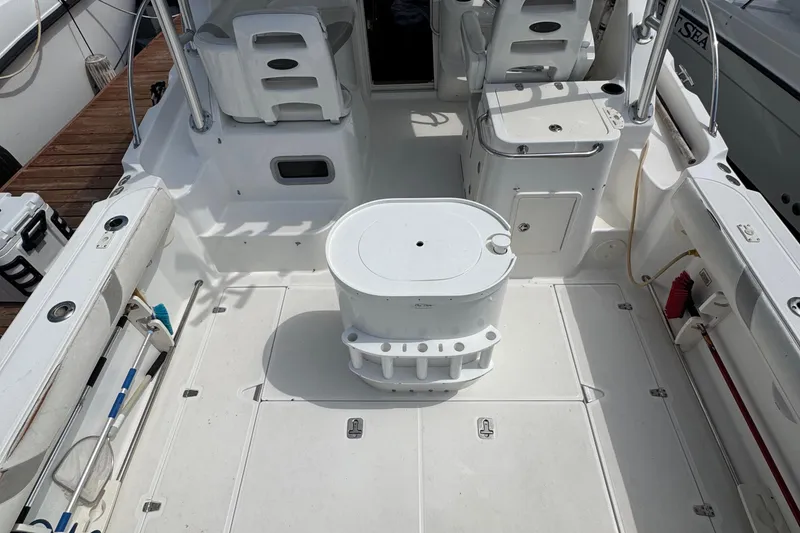 Slide: The Image of 2005 Boston Whaler 305 Conquest boat deck with seating and storage compartments. - 24