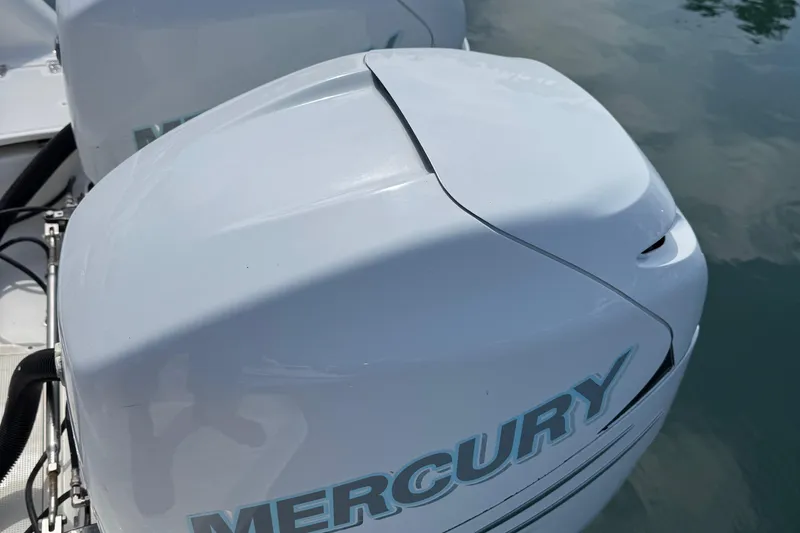 Slide: The Image of 2005 Boston Whaler 305 Conquest with Mercury outboard engine on water. - 31