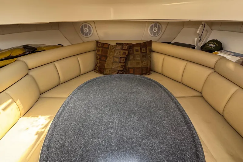 Slide: The Image of Interior cabin of 2005 Boston Whaler 305 Conquest with beige seating and table. - 38