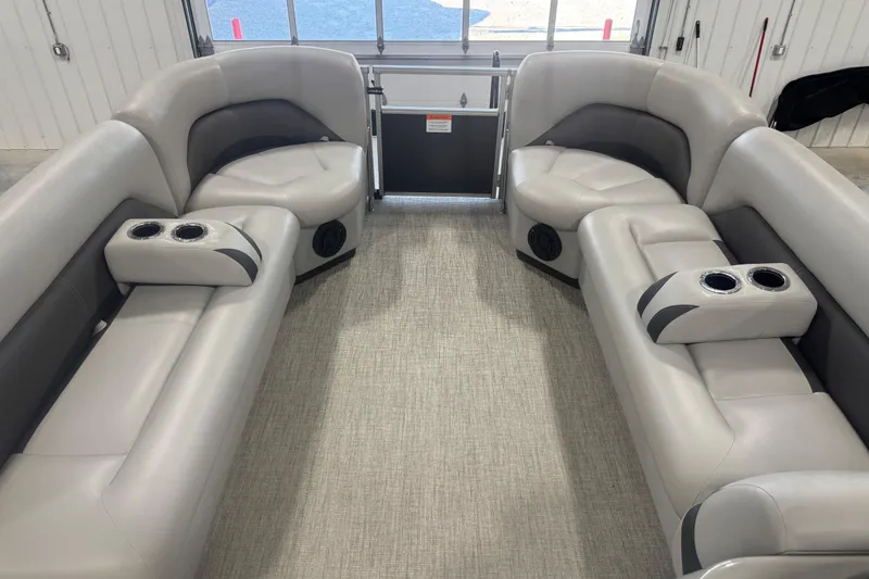 Slide: The Image of 2022 Landau Island Breeze 252 pontoon boat interior with plush seating and cup holders. - 10
