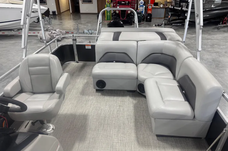 Slide: The Image of 2022 Landau Island Breeze 252 pontoon boat interior with gray seating and steering chair. - 11