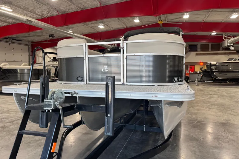 Slide: The Image of 2022 Landau Island Breeze 252 pontoon boat in a showroom with red ceiling. - 5