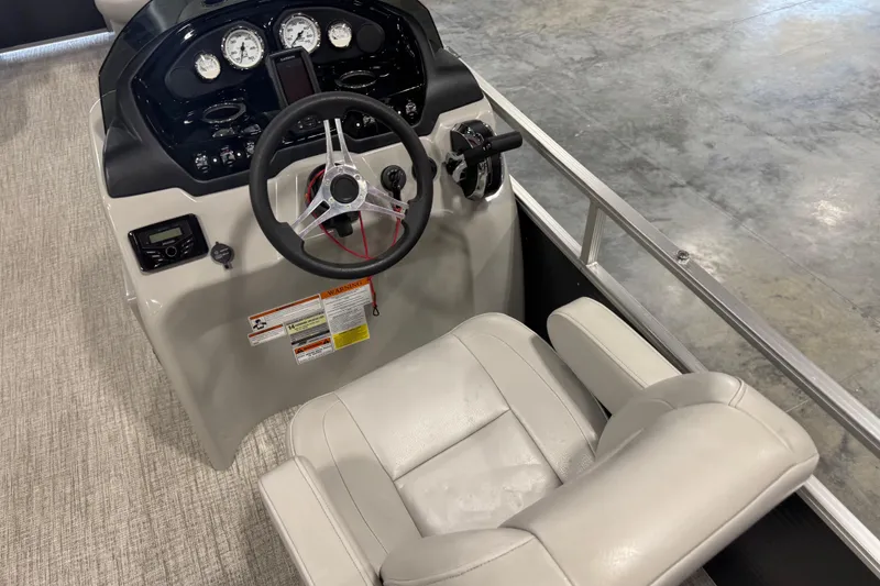 Slide: The Image of 2022 Landau Island Breeze 252 boat helm with steering wheel and gauges. - 7