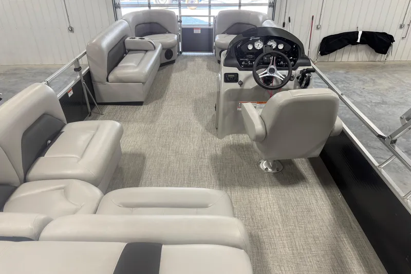 Slide: The Image of 2022 Landau Island Breeze 252 pontoon boat interior with plush seating and modern helm. - 8