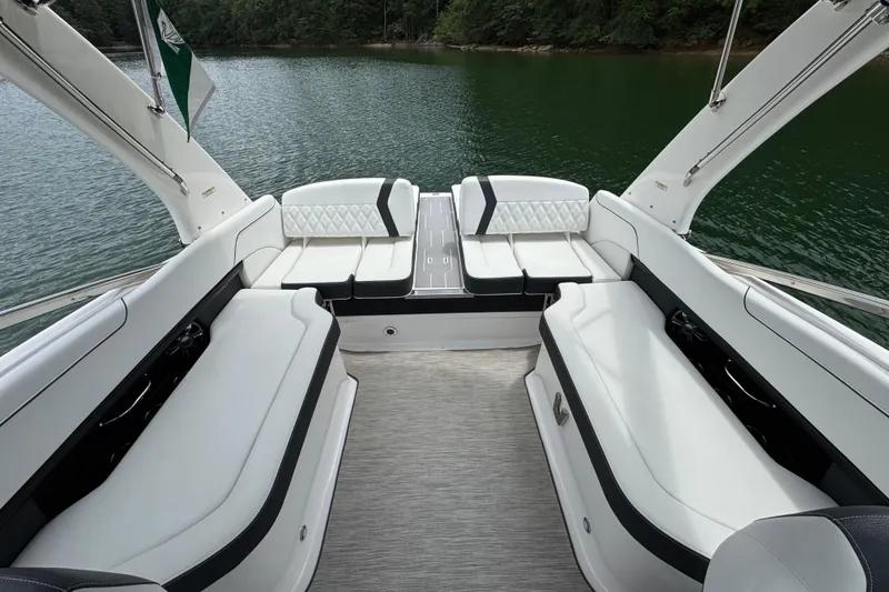Slide: The Image of 2018 Regal 2500 Bowrider interior with white seating on a serene lake. - 12