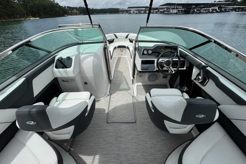 Slide: The Image of 2018 Regal 2500 Bowrider interior with sleek design, modern dashboard, and comfortable seating on a lake. - 15