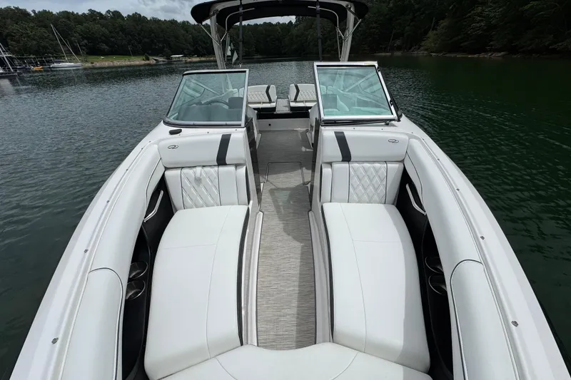 Slide: The Image of 2018 Regal 2500 Bowrider with white seating, on a serene lake. - 18
