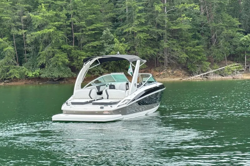 Slide: The Image of 2018 Regal 2500 Bowrider on a serene lake with lush forest backdrop. - 8