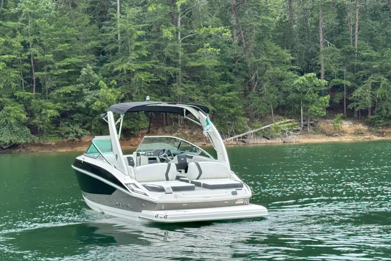 Slide: The Image of 2018 Regal 2500 Bowrider on a serene lake with lush forest backdrop. - 9