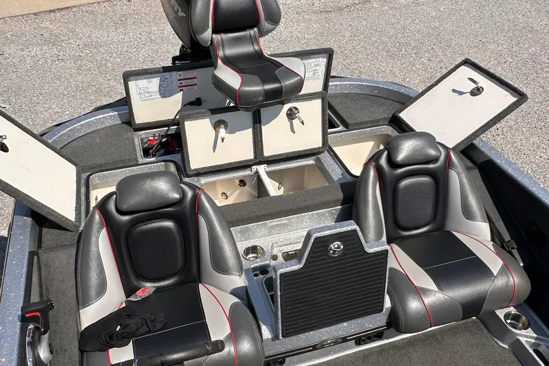 Slide: The Image of 2017 Ranger Z519 boat interior with open storage compartments and black leather seats. - 10