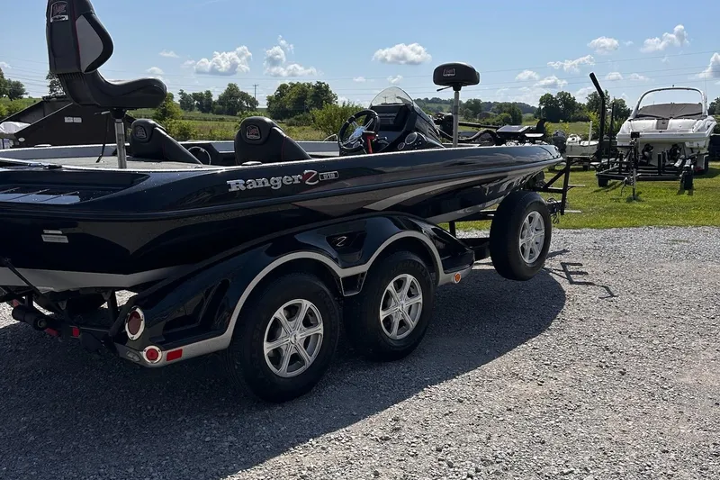 Slide: The Image of 2017 Ranger Z519 boat on a trailer, parked outdoors on gravel. - 22