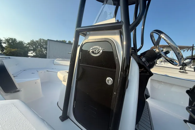 Slide: The Image of 2025 Tidewater 198 CC Adventure boat interior with steering wheel and seating. - 11