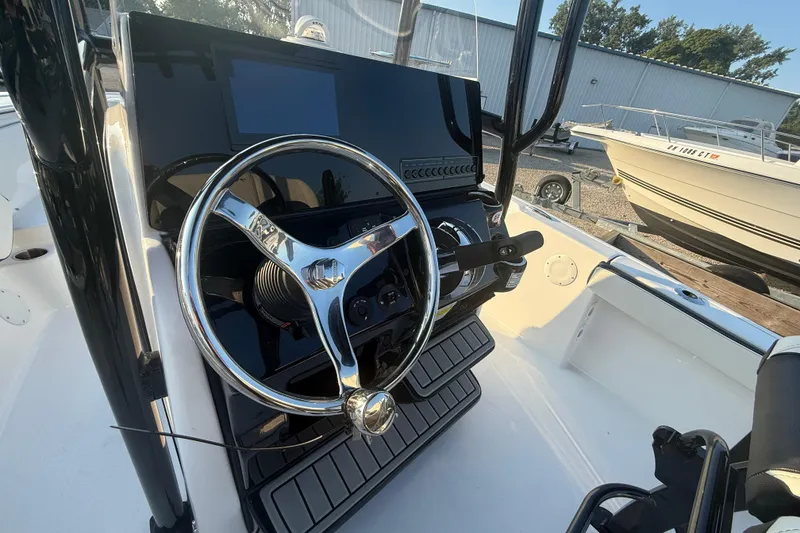 Slide: The Image of 2025 Tidewater 198 CC Adventure boat steering console with chrome details. - 9
