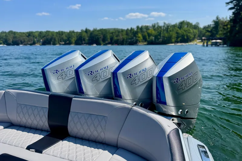 Slide: The Image of 2026 Nor-Tech 390 Sport Center Console with triple Racing 400 engines on a lake. - 12