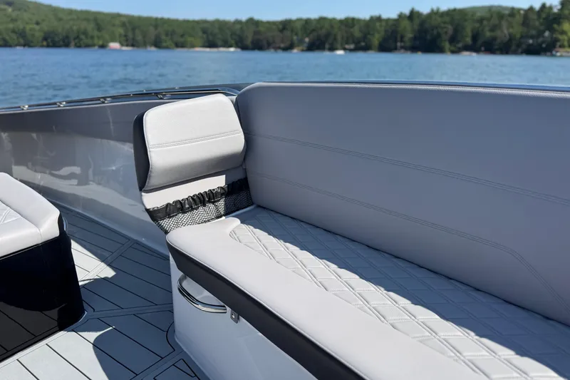 Slide: The Image of 2026 Nor-Tech 390 Sport Center Console boat with luxurious seating on a serene lake. - 15