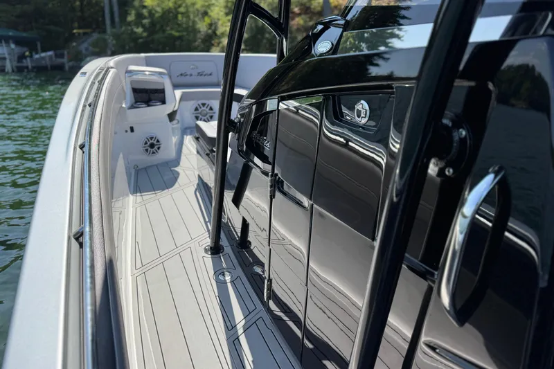 Slide: The Image of 2026 Nor-Tech 390 Sport Center Console boat with sleek design on calm water. - 19