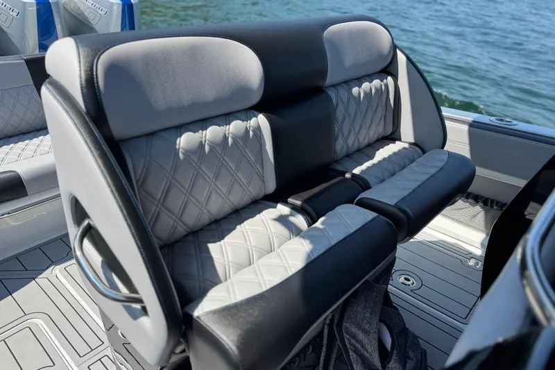 Slide: The Image of Luxury seating on 2026 Nor-Tech 390 Sport Center Console boat, featuring quilted upholstery. - 20