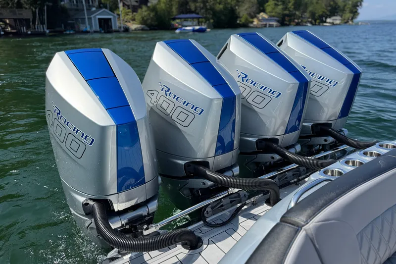 Slide: The Image of Four powerful outboard motors on a 2026 Nor-Tech 390 Sport Center Console boat. - 22
