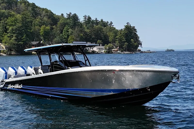 Slide: The Image of 2026 Nor-Tech 390 Sport Center Console boat on a scenic lake. - 3