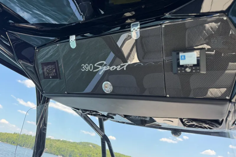 Slide: The Image of 2026 Nor-Tech 390 Sport Center Console dashboard with carbon fiber finish and digital displays. - 31