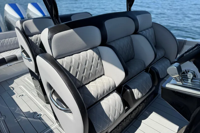 Slide: The Image of Luxurious seating on 2026 Nor-Tech 390 Sport Center Console boat, featuring quilted upholstery. - 32