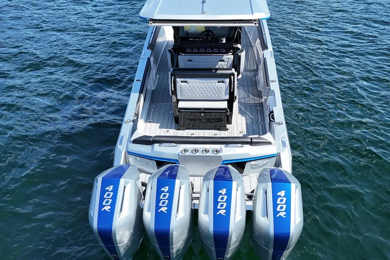 Slide: The Image of 2026 Nor-Tech 390 Sport Center Console boat with four powerful engines on open water. - 6