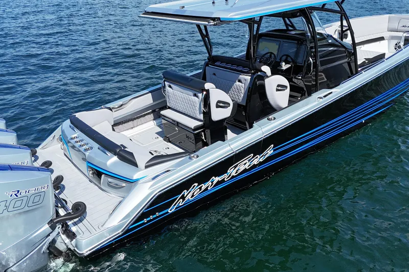 Slide: The Image of 2026 Nor-Tech 390 Sport Center Console boat on water, featuring sleek design and powerful engines. - 7