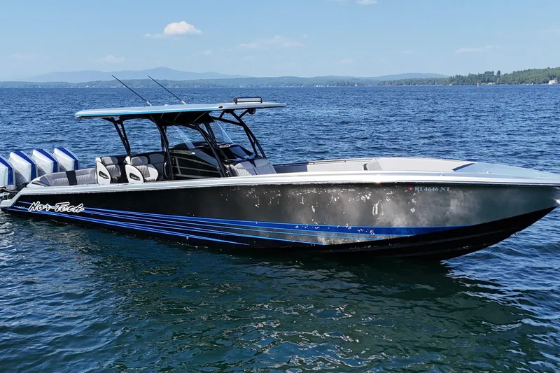 Slide: The Image of 2026 Nor-Tech 390 Sport Center Console boat on a serene lake. - 8