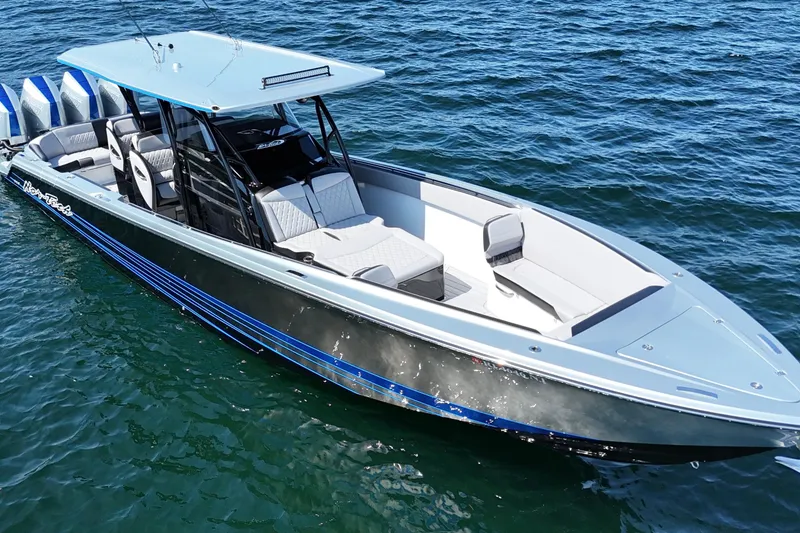 Slide: The Image of 2026 Nor-Tech 390 Sport Center Console boat on water, featuring sleek design and modern amenities. - 9